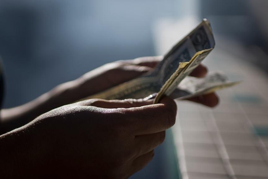 Counting money at a bazaar in smoke