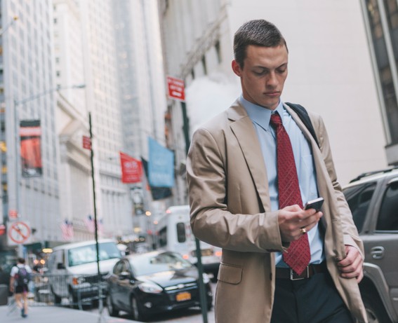 Young Professional Man in Suit Walking in New York's Wall Street