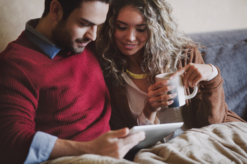 Young Caucasian Couple Using a Tablet at Home