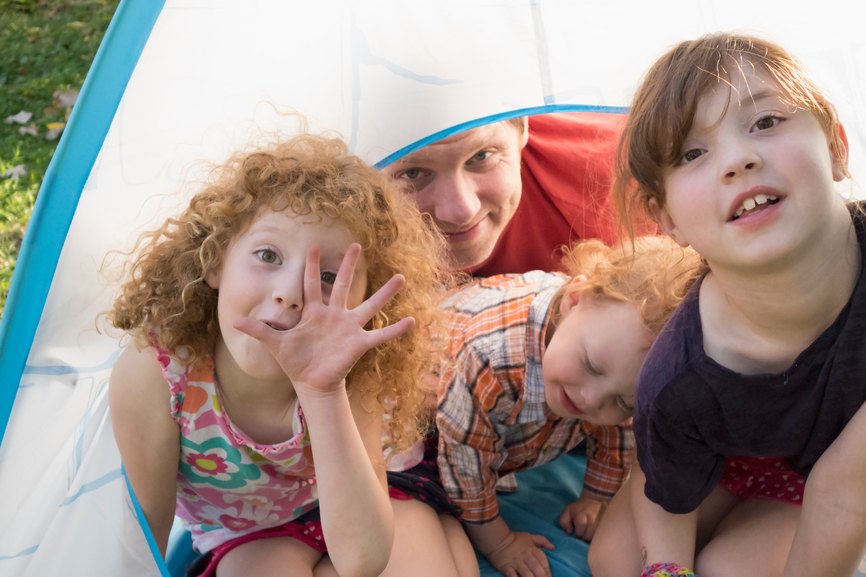 Family looking out from their small tent