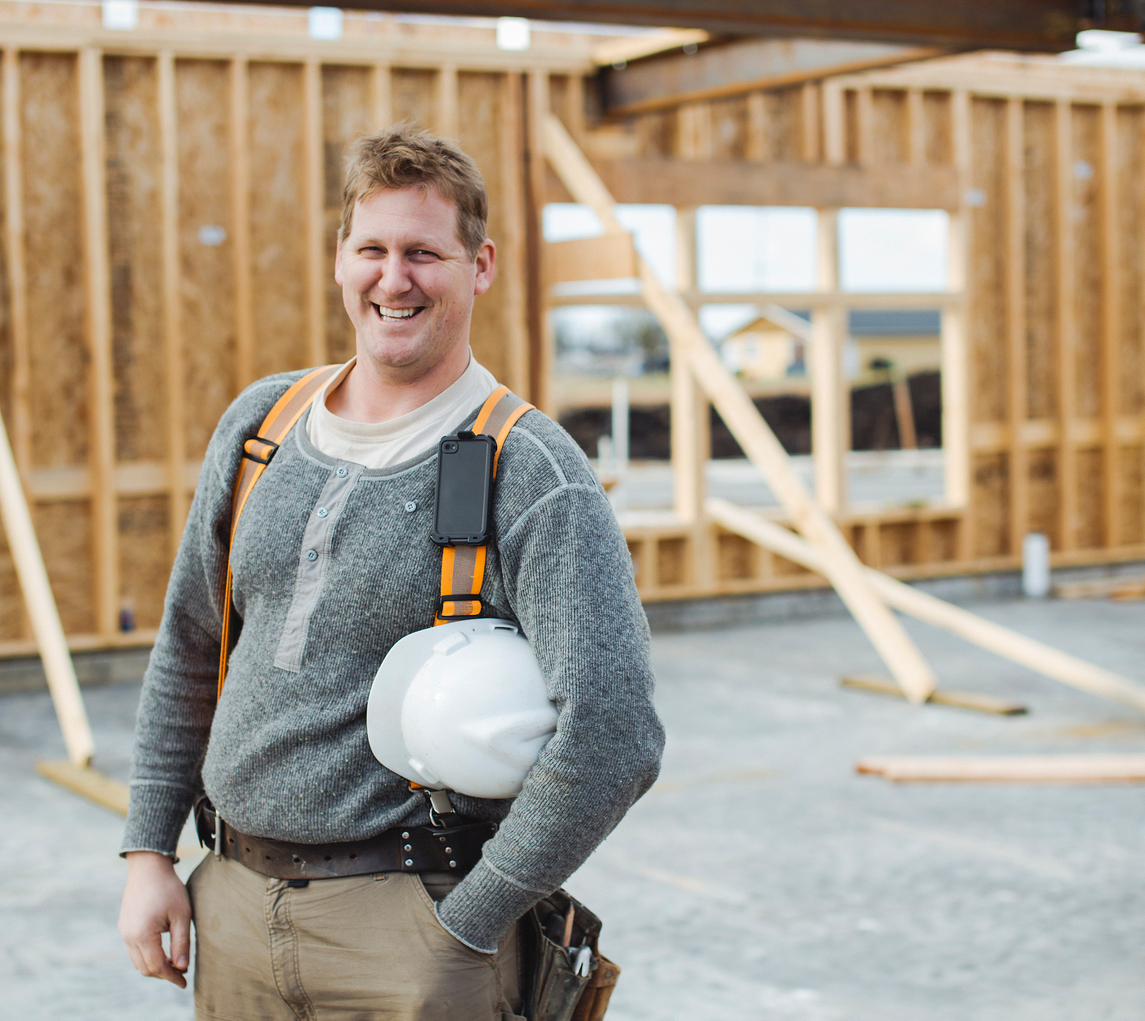 Portrait of smiling carpenter man at construction site